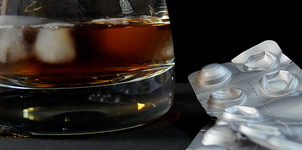medication blister pack beside rocks glass thumbnail