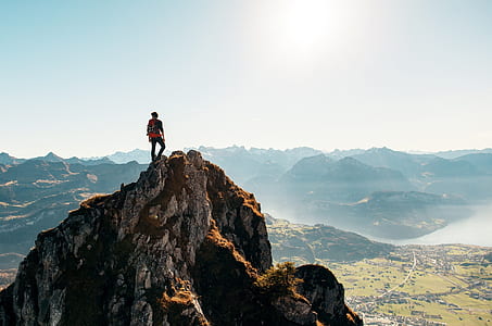 man standing on cliff at daytime thumbnail