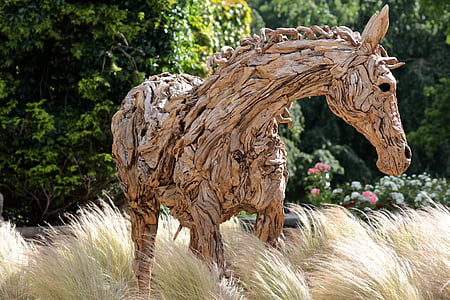 brown horse sculpture near green leaf trees thumbnail