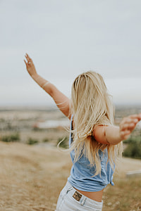 selective focus photo of woman wearing blue sleeveless top thumbnail