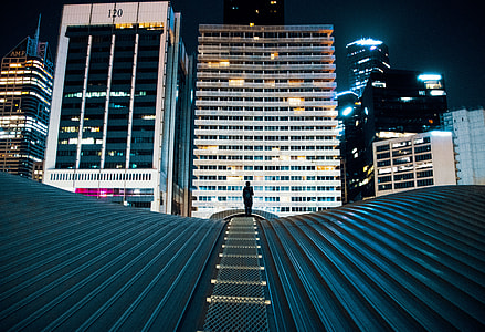 person walking on green metal road thumbnail