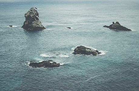 black rock in body of water thumbnail