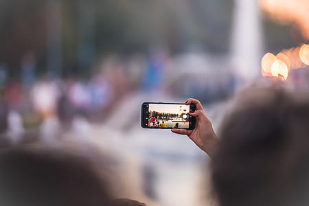 selective focus photography of person using smartphone to taking photo thumbnail