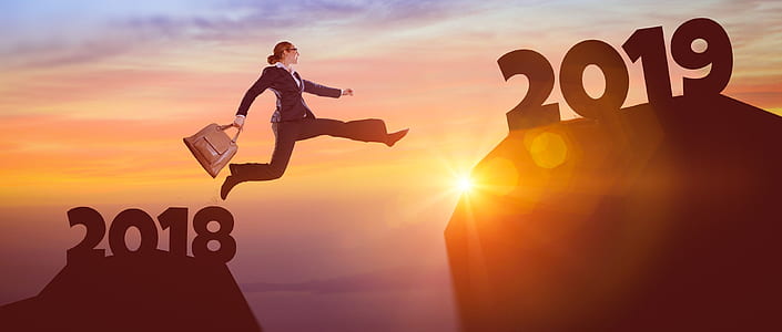 woman wearing black suit jumping from 2018 island to 2019 island thumbnail