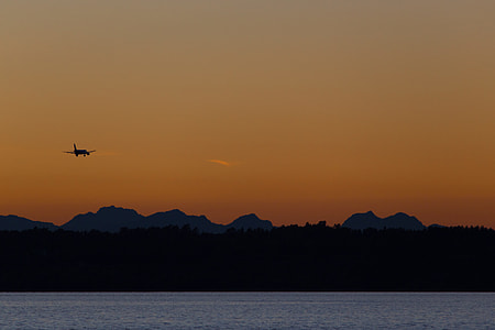 silhouette photography of quadcopter near body of water thumbnail