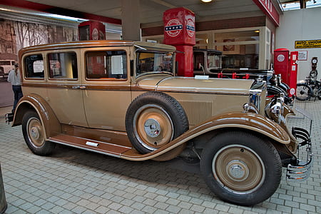 brown classic car on gas station thumbnail