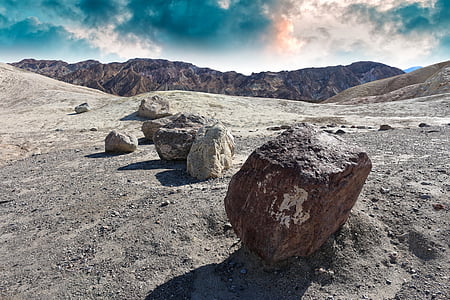 gray stones near mountain at daytime thumbnail