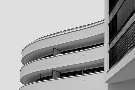 architectural photography of white curved concrete building thumbnail