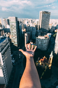 high-angle photography of left hand on high-rise buildngs thumbnail