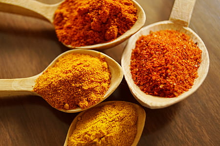 Four Assorted Spices On Wooden Spoons thumbnail