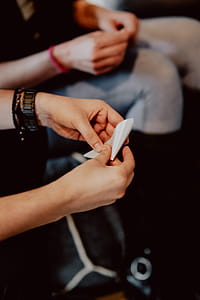 Women folding sheet of paper while making origami thumbnail