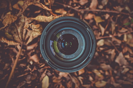 black telephoto lens on grass field thumbnail