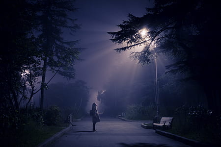 woman standing in front of utility post thumbnail