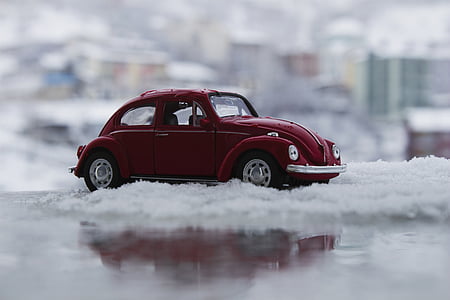 selective focus photography of red Volkswagen Beetle coupe scale model thumbnail