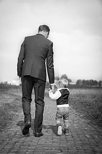 man holding toddler during daytime thumbnail