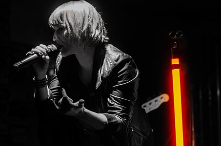 woman singing on stage grayscale photo thumbnail