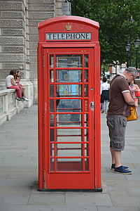 man standing near red Telephone booth thumbnail