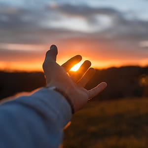 person in gray long-sleeved top showing hand during daytime thumbnail
