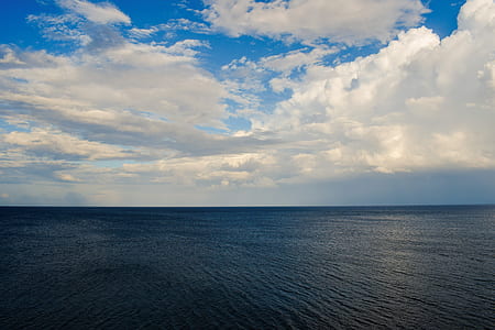 ocean under cloudy sky at daytime thumbnail
