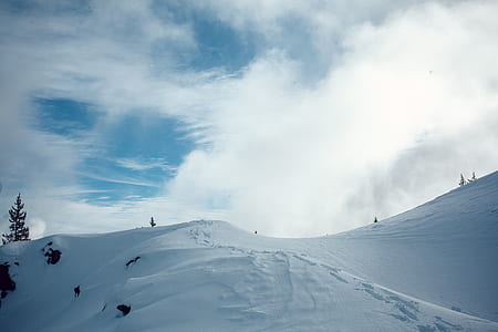 snow-covered hill during daytime thumbnail