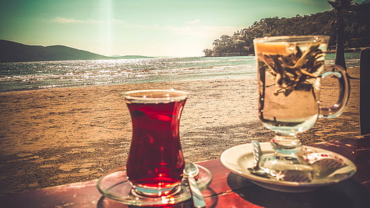 shallow focus photo of footed mug near body of water thumbnail