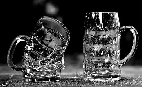 two clear beer mugs on gray surface thumbnail