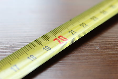 20 inches steel tape measure on brown wooden surface thumbnail