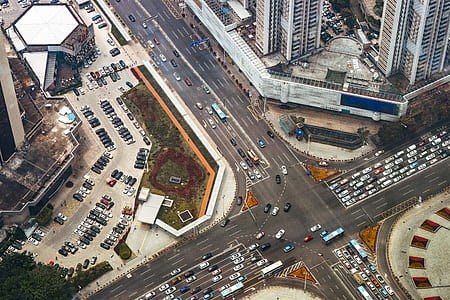 bird's eye view photography of roads, vehicles, and high-rise buildings thumbnail