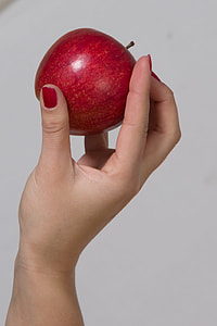 person holding red apple fruit thumbnail