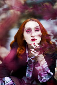 selective focus photography of woman holding her chin thumbnail