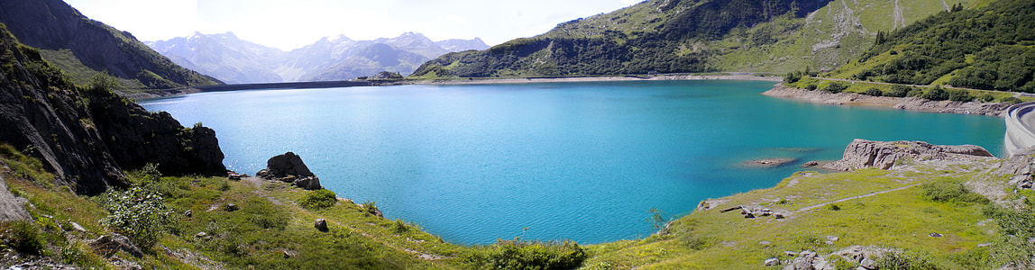 blue lake surrounded by mountains under blue sky during daytime thumbnail