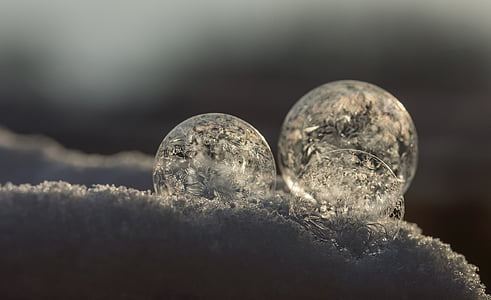 three round ornaments on snow closeup photo thumbnail