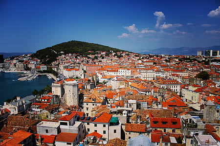 aerial photo of white-and-orange buildings near body of water thumbnail