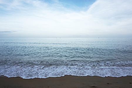 ocean waves on seashore under cloudy sky thumbnail