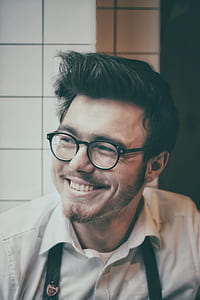 man smiling wearing white collared shirt and black framed eyeglasses thumbnail