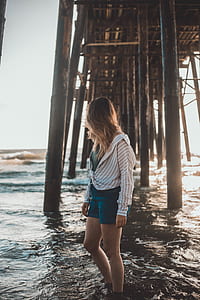 women under wooden dock on shore thumbnail