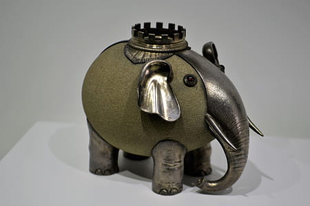silver and green elephant figurine placed on tabletop thumbnail