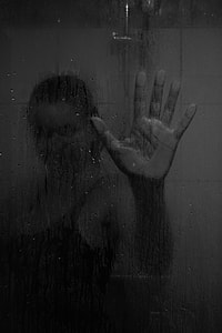 woman with her hand on glass thumbnail