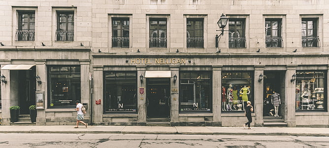 people walking beside gray concrete building during daytime thumbnail