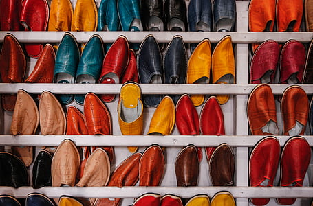shoe lot on white wooden rack thumbnail