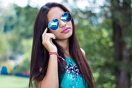 woman holding her sunglasses thumbnail