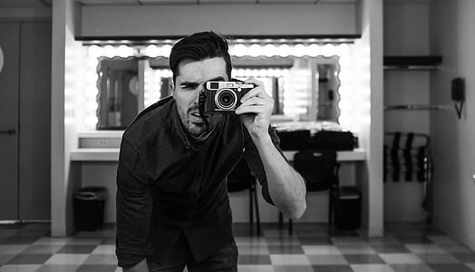 man holding camera thumbnail
