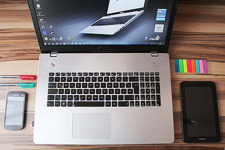 silver Asus laptop computer beside black tablet computer thumbnail