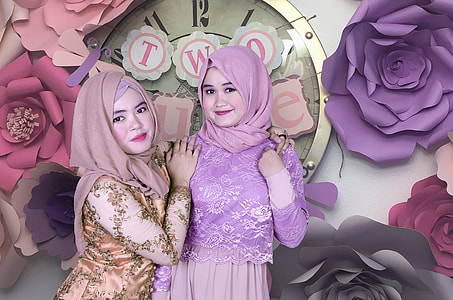 two woman on floral background photo thumbnail