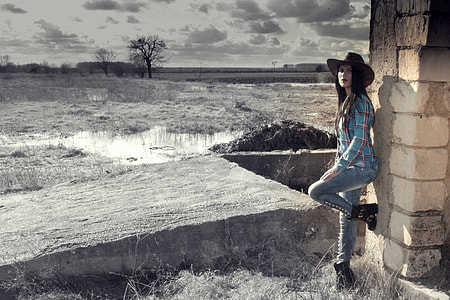 woman leaning on gray concrete wall thumbnail