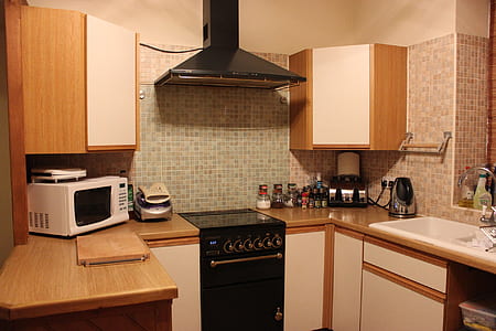 white countertop microwave near kitchen cabinet thumbnail