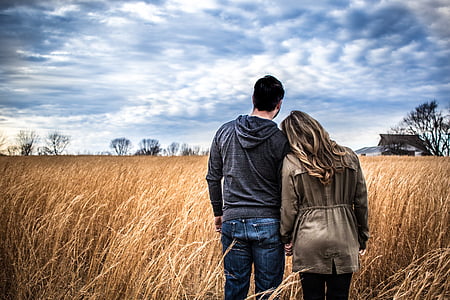 man and woman standing in field thumbnail