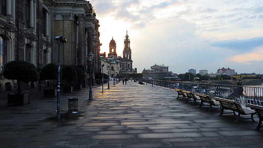 brown benches on gray concrete pathway near street lights thumbnail