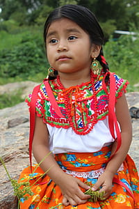 girl sitting on rock during daytime thumbnail