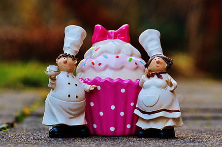 selective focus photography of ceramic male and female figurines thumbnail